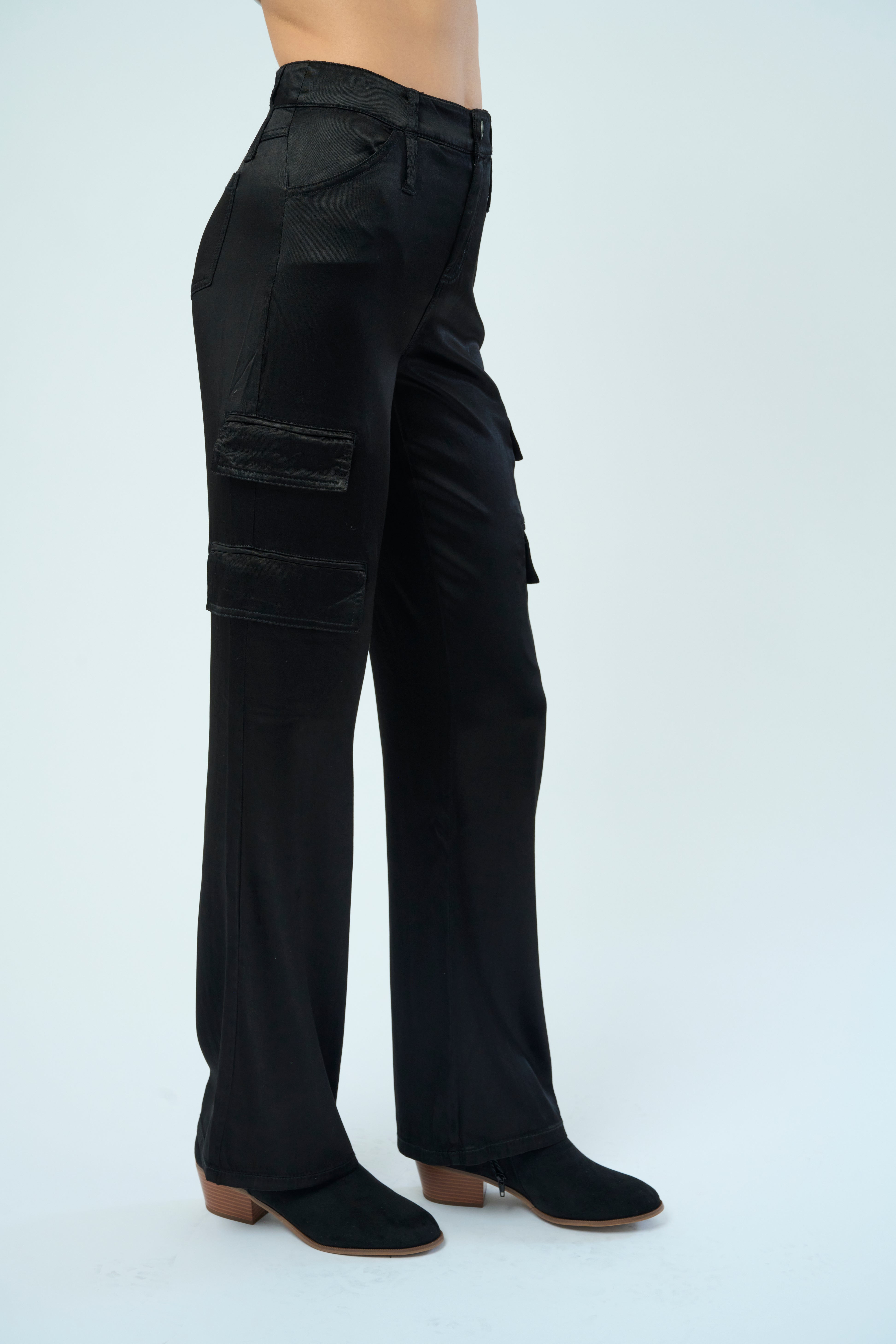 Side view of a tall female model confidently posing wearing our black colored Zendaya Stretch Viscose Satin Wide Leg Pant from Marrakech Clothing.