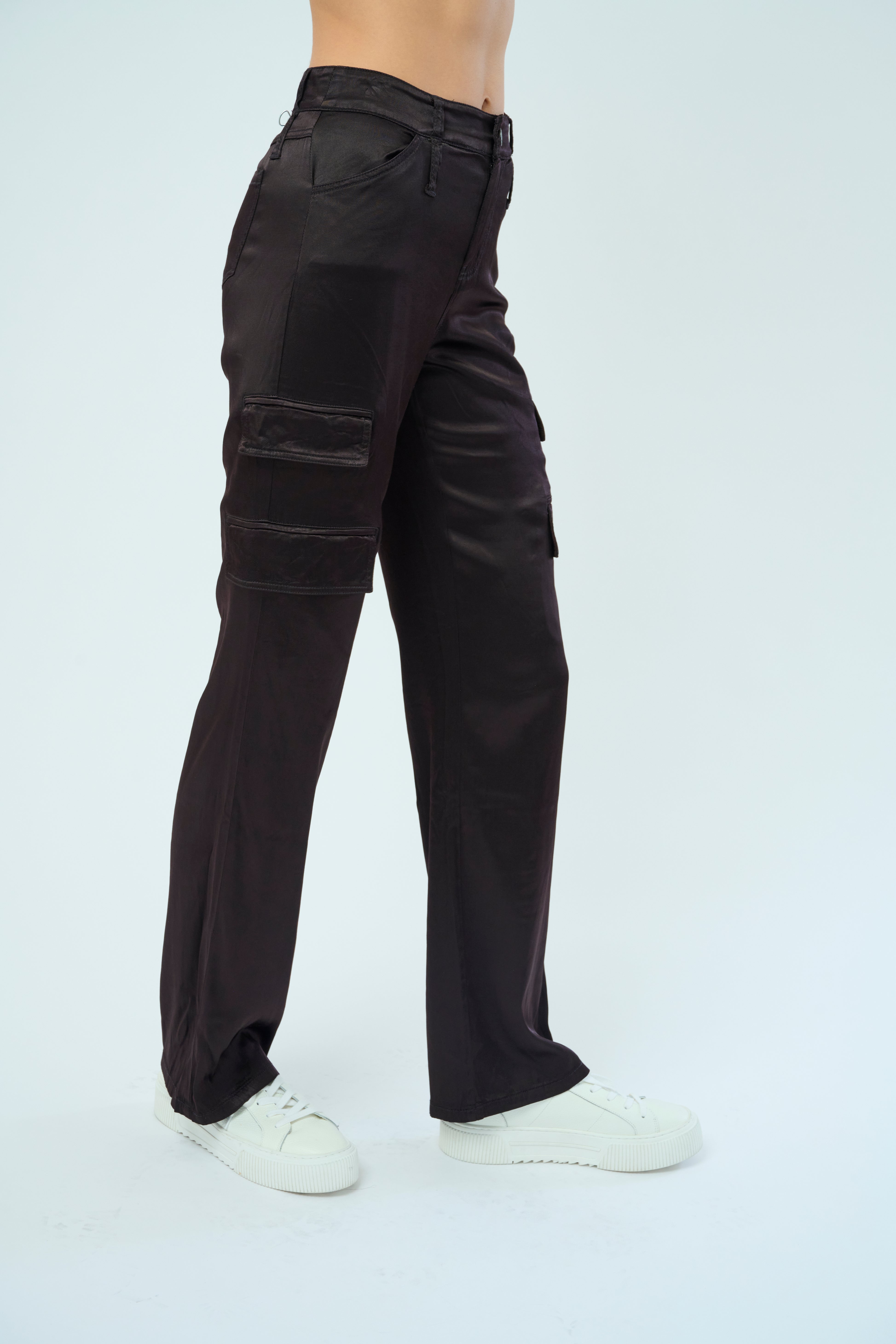 Side view of a tall female model confidently posing wearing our dark chocolate colored Zendaya Stretch Viscose Satin Wide Leg Pant from Marrakech Clothing.