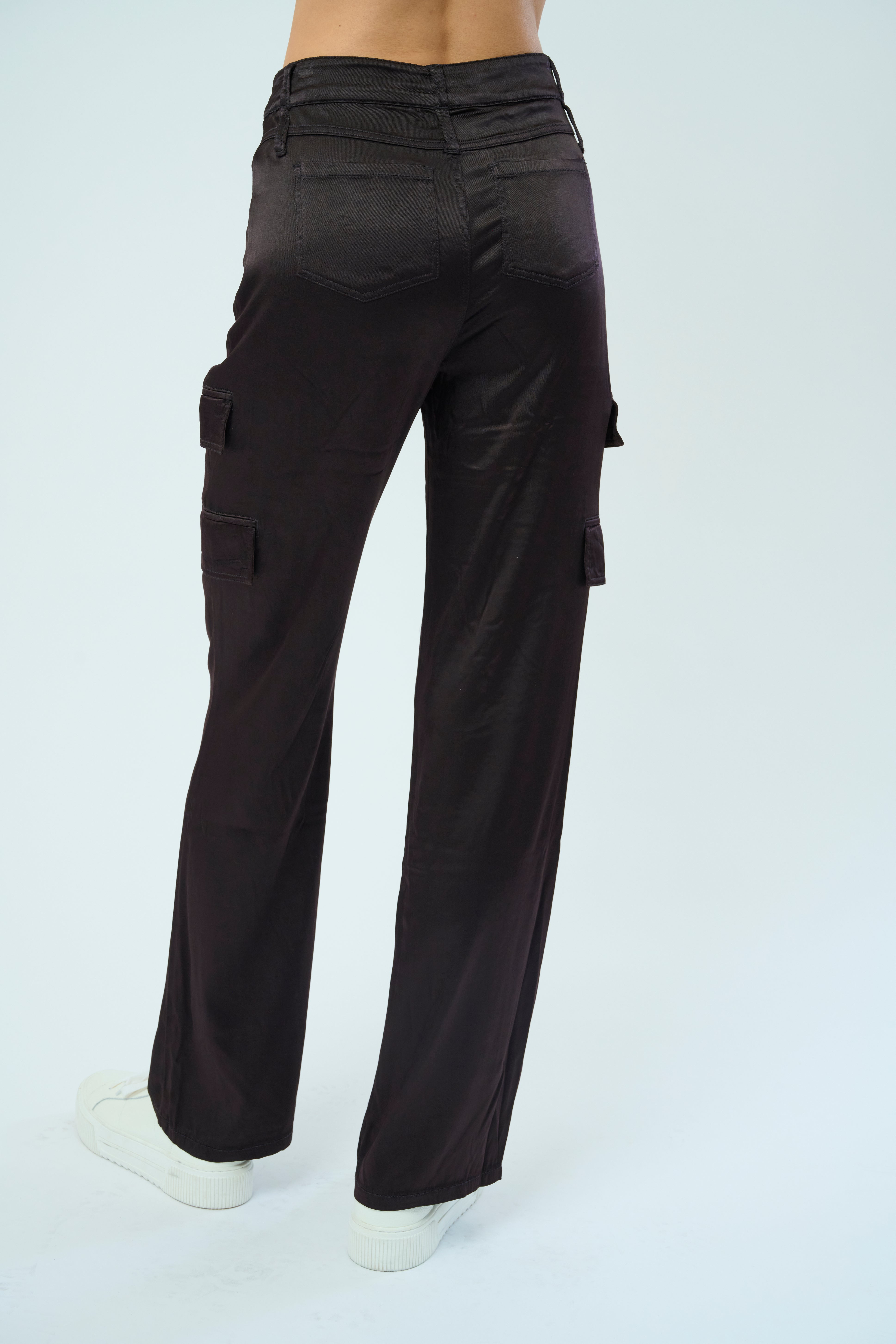 Back view of a tall female model confidently posing wearing our dark chocolate colored Zendaya Stretch Viscose Satin Wide Leg Pant from Marrakech Clothing.