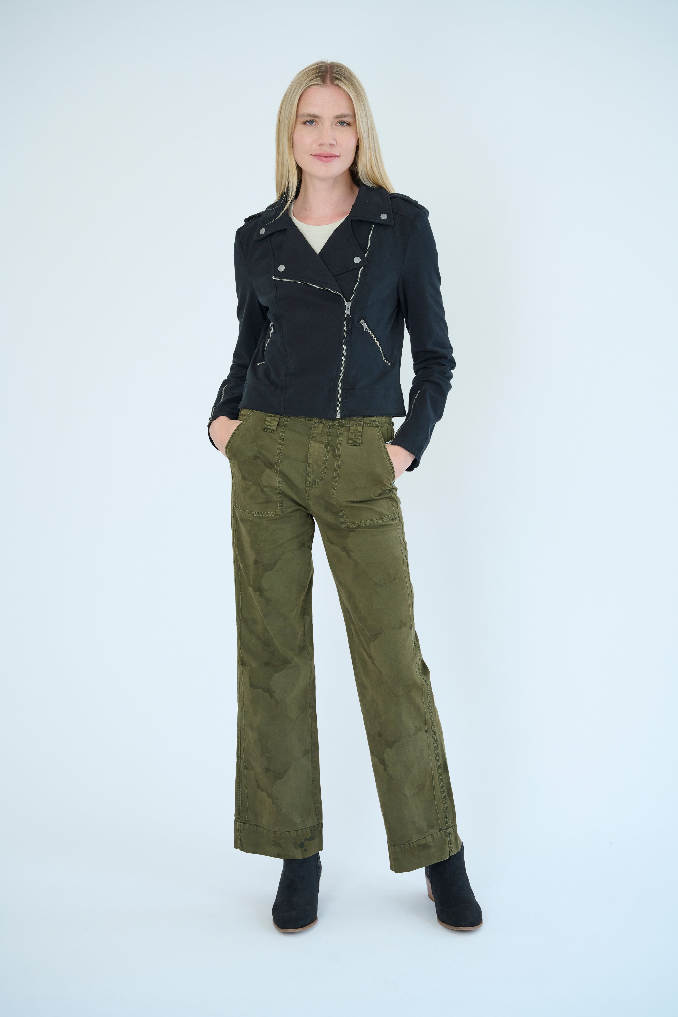 Front view of model wearing Darilyn pant in Pine Camo color and Layla Jacket in Black color