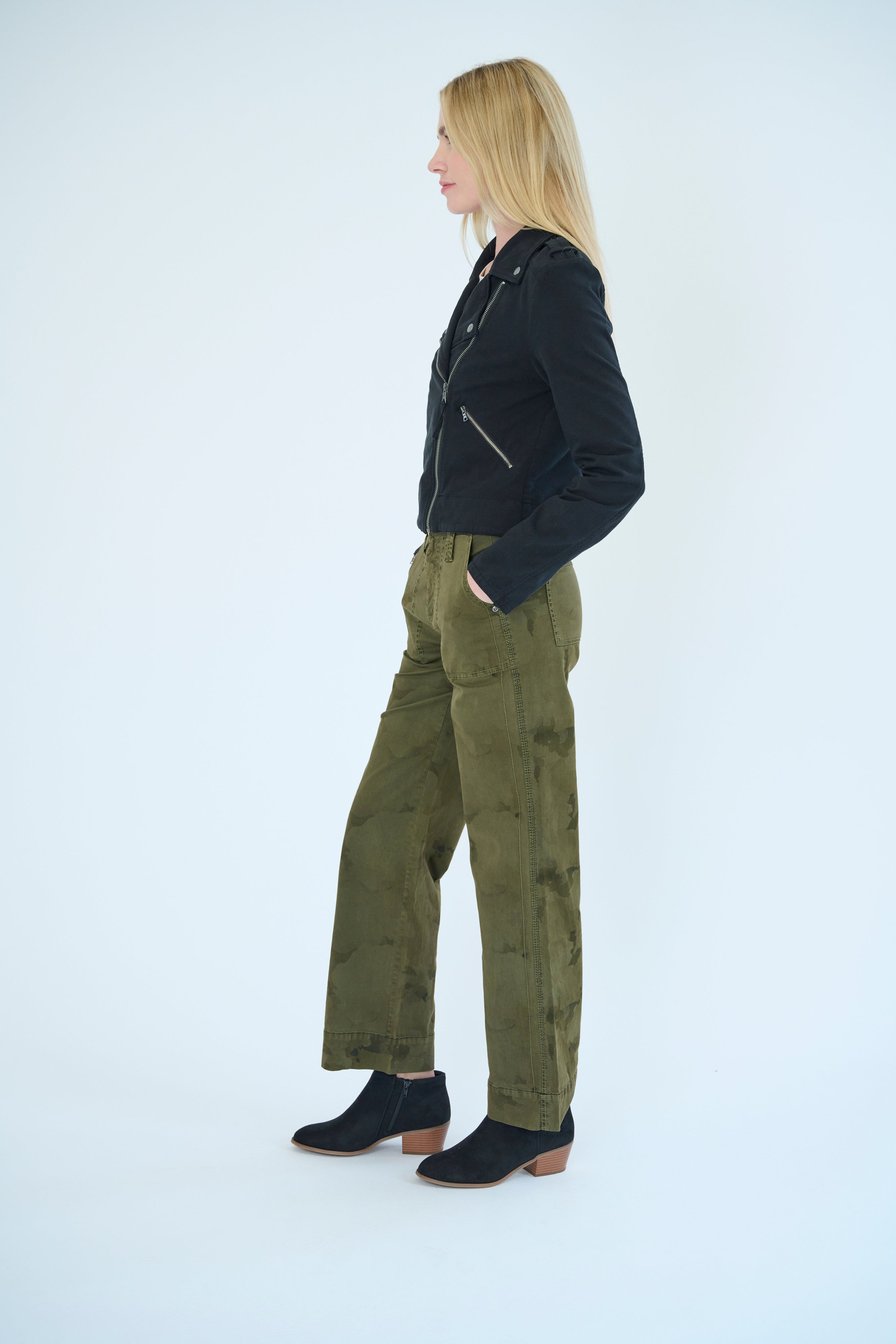 Side view of model wearing Darilyn pant in Pine Camo color and Layla Jacket in Black color