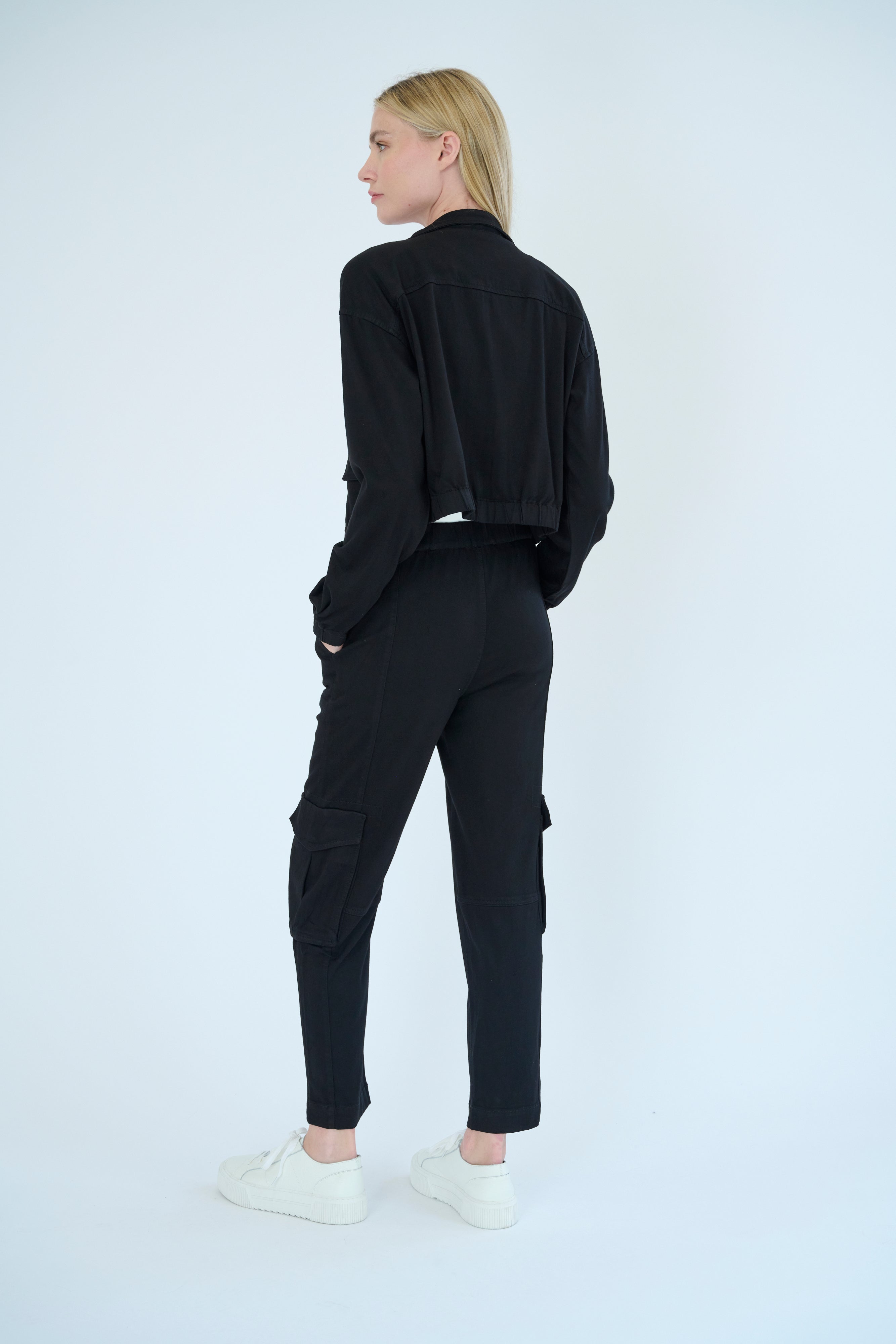 Back view of model wearing Nelle jacket and Raisa pant in Black color. 