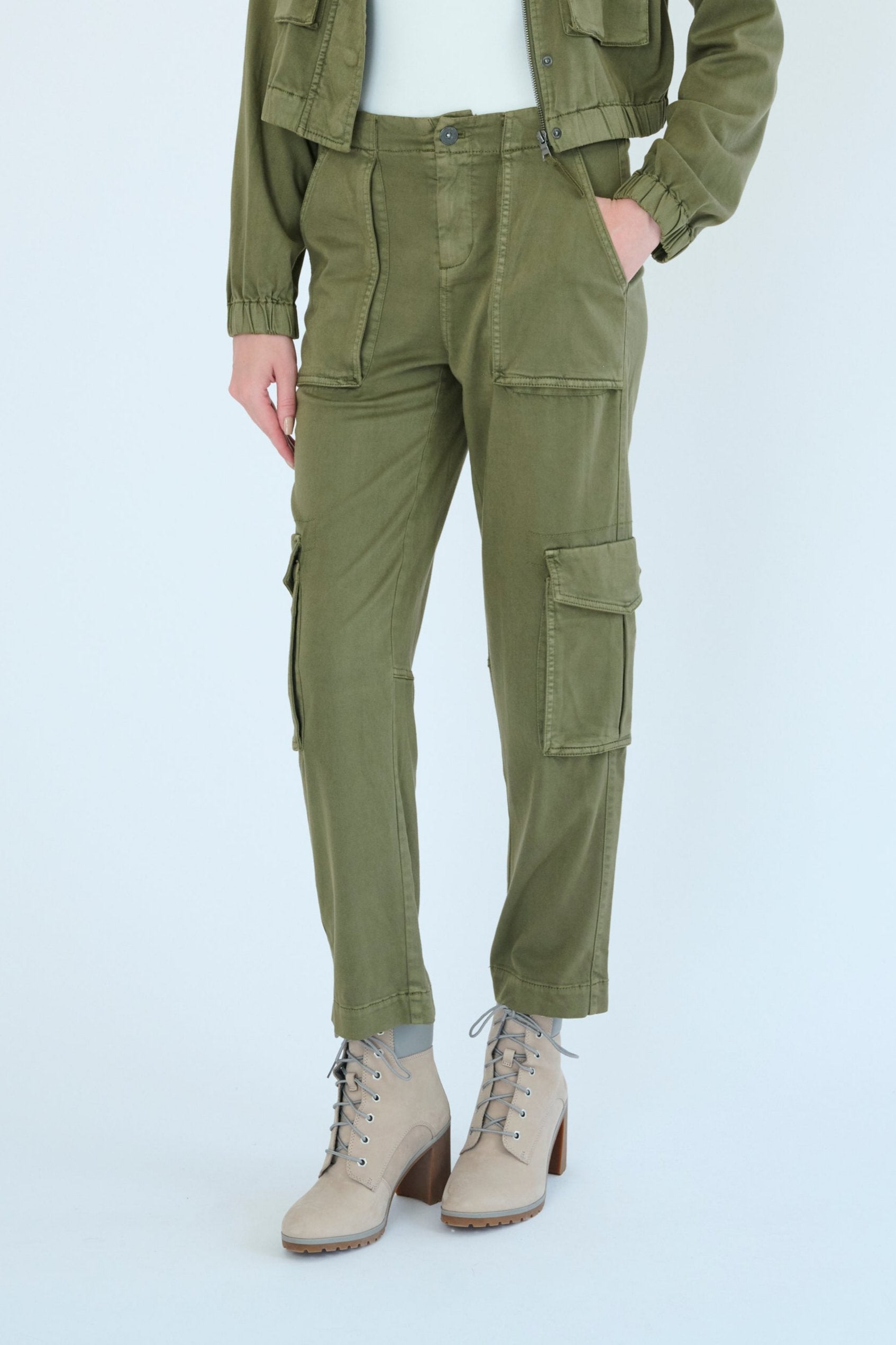 Front view of model wearing Raisa pant in Pine color